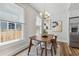 Bright dining room with modern chandelier, stylish decor, and view of the fenced-in backyard at 307 S Newport Ave, Tampa, FL 33606