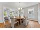 Dining room featuring hardwood floors, neutral colors, an elegant chandelier, and views into the living room at 307 S Newport Ave, Tampa, FL 33606