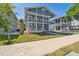 Charming blue two-story home featuring double porches, white railings, and a neatly landscaped front yard on a sunny day at 307 S Newport Ave, Tampa, FL 33606