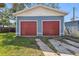 Detached two-car garage with red doors and a well-maintained exterior with space for parking at 307 S Newport Ave, Tampa, FL 33606
