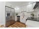 Modern kitchen featuring stainless steel appliances, white cabinets, granite countertops, and wood-look flooring at 307 S Newport Ave, Tampa, FL 33606