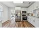 Bright, modern kitchen with white cabinets, stainless steel appliances, and hardwood flooring at 307 S Newport Ave, Tampa, FL 33606