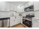 Modern kitchen featuring stainless steel appliances, white cabinets, and quartz countertops at 307 S Newport Ave, Tampa, FL 33606