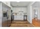 Modern kitchen with white cabinets, stainless steel appliances, and hardwood floors at 307 S Newport Ave, Tampa, FL 33606