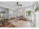 Cozy living room featuring a fireplace, hardwood floors, and ample natural light from the large windows at 307 S Newport Ave, Tampa, FL 33606