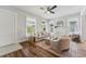 Living room featuring wood-look flooring, a neutral color palette, and many windows at 307 S Newport Ave, Tampa, FL 33606