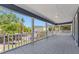 Spacious covered porch with decorative tile flooring and views of lush greenery at 307 S Newport Ave, Tampa, FL 33606