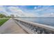Scenic waterfront view with a concrete walkway and city skyline in the background under a bright blue sky with puffy clouds at 307 S Newport Ave, Tampa, FL 33606