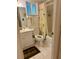 Bathroom with shower/tub combo with neutral tile, and patterned shower curtain at 3516 Lake Bayshore Dr # K109, Bradenton, FL 34205