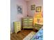 Charming bedroom with a matching set of dressers and floral wall art at 3516 Lake Bayshore Dr # K109, Bradenton, FL 34205