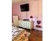 Cozy bedroom featuring a dresser, TV, and chair with heart design at 3516 Lake Bayshore Dr # K109, Bradenton, FL 34205
