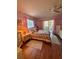 Spacious bedroom featuring a ceiling fan, lamps, and outdoor patio access at 3516 Lake Bayshore Dr # K109, Bradenton, FL 34205