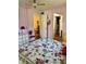 Cozy bedroom with a floral comforter, pink walls, and access to a sitting room and closet at 3516 Lake Bayshore Dr # K109, Bradenton, FL 34205