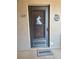 Close-up of front door with a seasonal decoration and welcome mat, showcasing condo's entry at 3516 Lake Bayshore Dr # K109, Bradenton, FL 34205