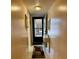 Hallway view of the entrance with a white accent table and neutral colored walls at 3516 Lake Bayshore Dr # K109, Bradenton, FL 34205