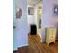 Hallway leading to bathroom, with view of vanity mirror and neutral tile at 3516 Lake Bayshore Dr # K109, Bradenton, FL 34205