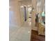 Hallway with tile flooring leading to a bathroom and living spaces, featuring a decorative mirror at 3516 Lake Bayshore Dr # K109, Bradenton, FL 34205