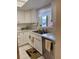 Kitchen featuring stainless steel appliances, white cabinets, and plenty of counter space at 3516 Lake Bayshore Dr # K109, Bradenton, FL 34205