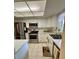 Well-lit kitchen with stainless appliances, light countertops, and tiled flooring at 3516 Lake Bayshore Dr # K109, Bradenton, FL 34205