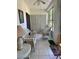 Sunroom with white wicker furniture, tile flooring, and views of the outdoor area at 3516 Lake Bayshore Dr # K109, Bradenton, FL 34205