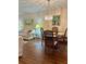 Open-concept living and dining area with hardwood floors, chandelier, and bright natural light at 3516 Lake Bayshore Dr # K109, Bradenton, FL 34205
