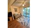 Comfortable living room with a plaid sofa, golf decor, and sliding doors to the outside at 3516 Lake Bayshore Dr # K109, Bradenton, FL 34205