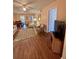 Bright living room featuring a ceiling fan, wood floors, and a view into the dining area at 3516 Lake Bayshore Dr # K109, Bradenton, FL 34205