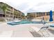Community pool with lounge chairs and palm trees, offering a relaxing atmosphere at 3516 Lake Bayshore Dr # K109, Bradenton, FL 34205