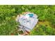 Stunning aerial view of home with a private pool, beautiful landscaping and surrounded by lush trees at 380 Wellington Ave, Oldsmar, FL 34677