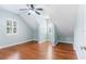 Charming bedroom with hardwood floors, vaulted ceilings, and natural light from a window at 380 Wellington Ave, Oldsmar, FL 34677