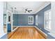 Versatile room with hardwood floors, neutral walls, plantation shutters, and a mirrored accent wall at 380 Wellington Ave, Oldsmar, FL 34677