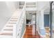Inviting entryway with hardwood floors, staircase, and view into the living room with a fireplace at 380 Wellington Ave, Oldsmar, FL 34677