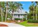 Inviting home with a classic design, surrounded by mature trees, showcasing curb appeal and charm at 380 Wellington Ave, Oldsmar, FL 34677
