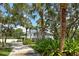 Beautiful home with lush landscaping, long driveway, and a multi-story back porch at 380 Wellington Ave, Oldsmar, FL 34677
