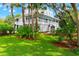 Well-manicured front yard showcasing a beautiful home with mature landscaping and lush green lawn at 380 Wellington Ave, Oldsmar, FL 34677