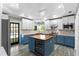 Modern kitchen with custom cabinets, a unique center island with a wine cooler, and stainless steel appliances at 380 Wellington Ave, Oldsmar, FL 34677