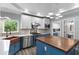 Modern kitchen features custom cabinets, stainless steel appliances, brick backsplash, and a large sink at 380 Wellington Ave, Oldsmar, FL 34677