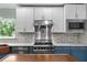 A spacious kitchen featuring stainless steel appliances, white cabinets, and a copper topped island at 380 Wellington Ave, Oldsmar, FL 34677