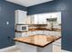 Modern kitchen with white cabinets, wood countertops, and stainless steel microwave at 380 Wellington Ave, Oldsmar, FL 34677