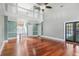 Bright, open living room featuring high ceilings, gleaming hardwood floors, and a staircase to the second level at 380 Wellington Ave, Oldsmar, FL 34677