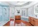 A bright and open bathroom with a walk in shower, jacuzzi, and dual vanity at 380 Wellington Ave, Oldsmar, FL 34677