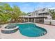 Backyard oasis featuring a pool, spa, and multi-level outdoor living spaces at 380 Wellington Ave, Oldsmar, FL 34677