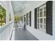 Inviting porch with rocking chairs, white columns, and ample space for outdoor relaxation at 380 Wellington Ave, Oldsmar, FL 34677