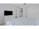 Bedroom featuring a comfortable bed and a dresser with a mounted television at 3827 Trophy Blvd # 0, New Port Richey, FL 34655