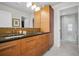 Bathroom with double sinks, wooden cabinets, granite countertop, and glass door shower at 400 4Th S Ave # 401, St Petersburg, FL 33701