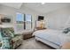 Bedroom with white shuttered window, light walls and ceiling fan, plus seating area at 400 4Th S Ave # 401, St Petersburg, FL 33701