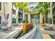 Modern building entrance featuring palm trees, a water feature, and glass doors at 400 4Th S Ave # 401, St Petersburg, FL 33701
