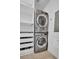Efficient laundry area with stacked washer and dryer, and built in shelving for storage at 400 4Th S Ave # 401, St Petersburg, FL 33701