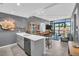 Open living room with modern lighting, breakfast bar, and sliding glass doors to a balcony at 400 4Th S Ave # 401, St Petersburg, FL 33701