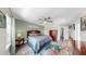 Main bedroom with ceiling fan, colorful area rug, and hardwood floors at 4002 Carrollwood Palm Ct, Tampa, FL 33624